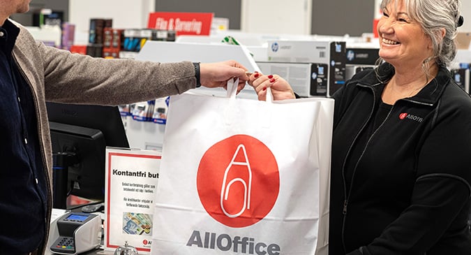 Kvinna som ger en AllOffice-påse till kund
