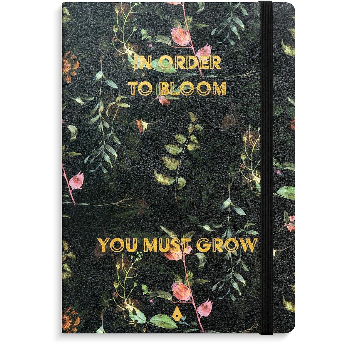 Anteckningsbok med blomsterdesign och texten In order to bloom you must grow