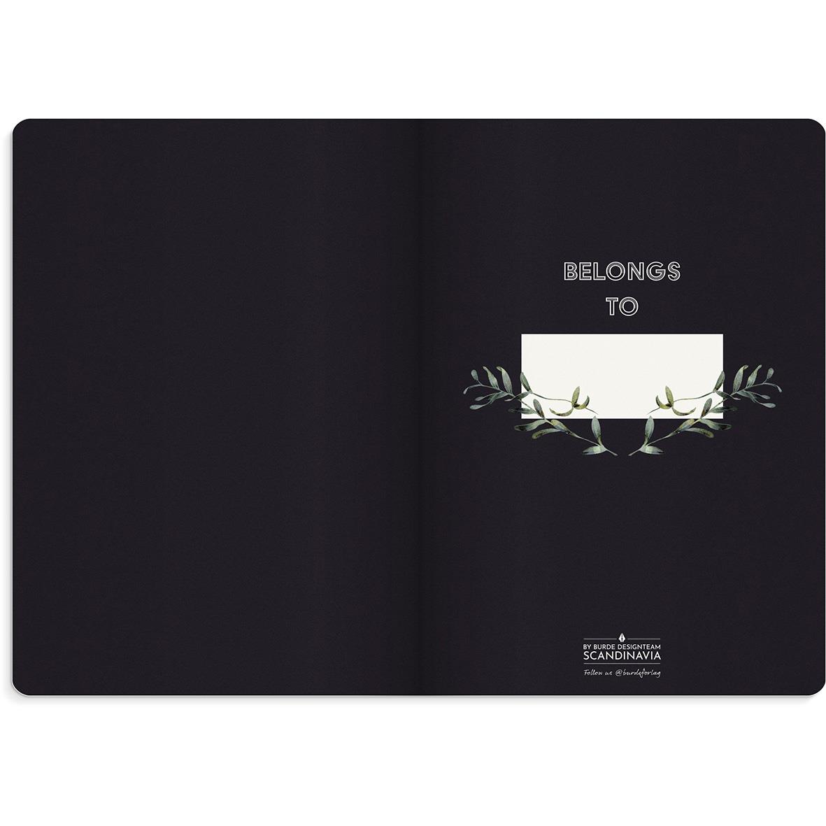 Svart anteckningsbok med blomsterdesign och texten BELONGS TO på insidan