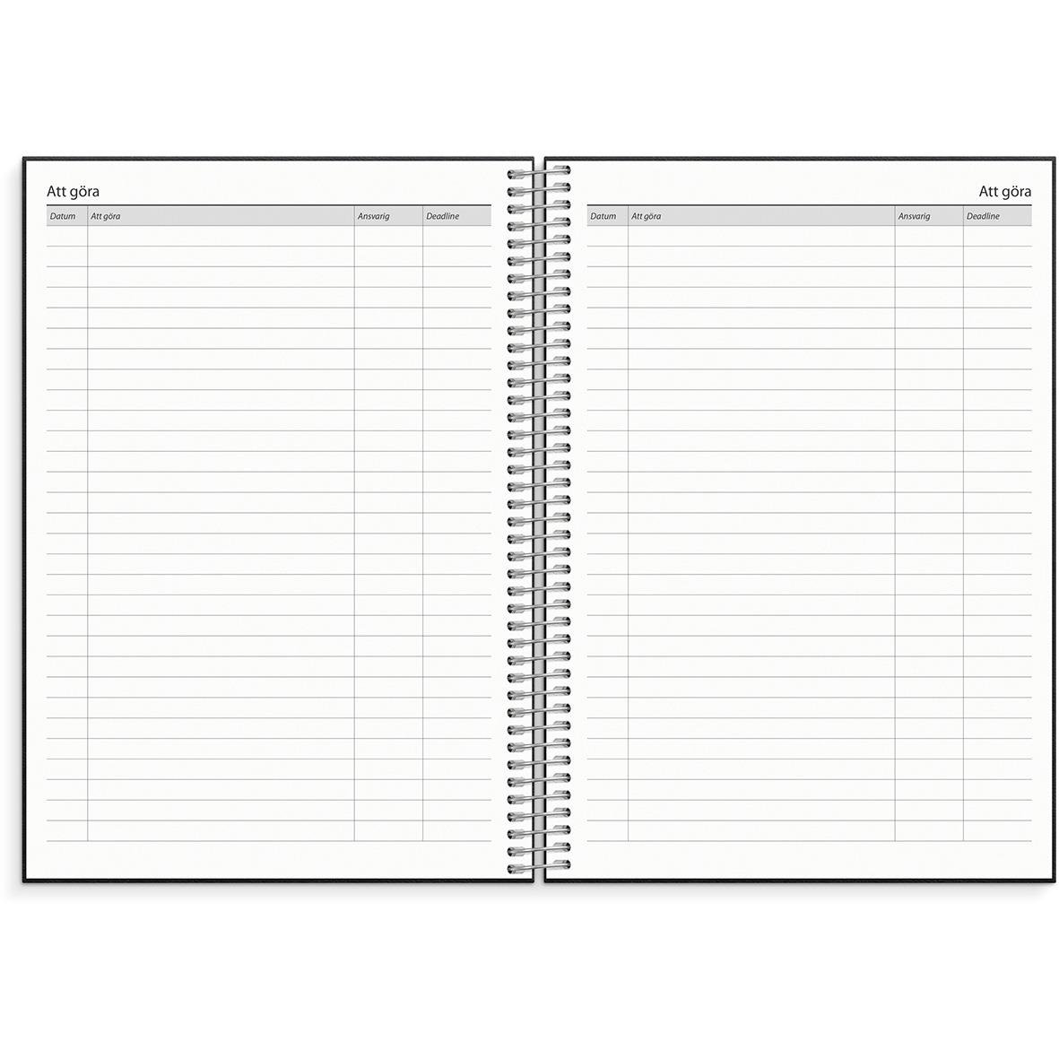 Öppnad almanacka för 2026 med konstläderomslag och veckoplanering