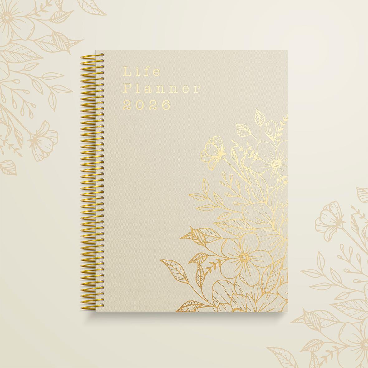 Vårens almanacka för 2026 med guldfolierad text och blommönster på omslaget