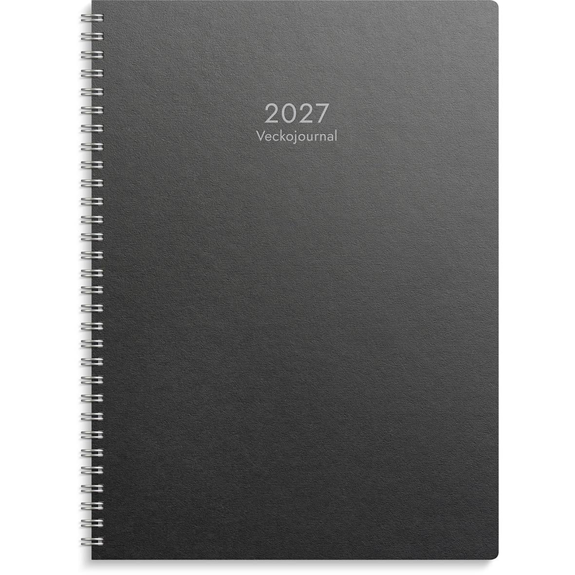 Svart veckojournal för 2026 med spiralrygg och texten 2026 Veckojournal på framsidan