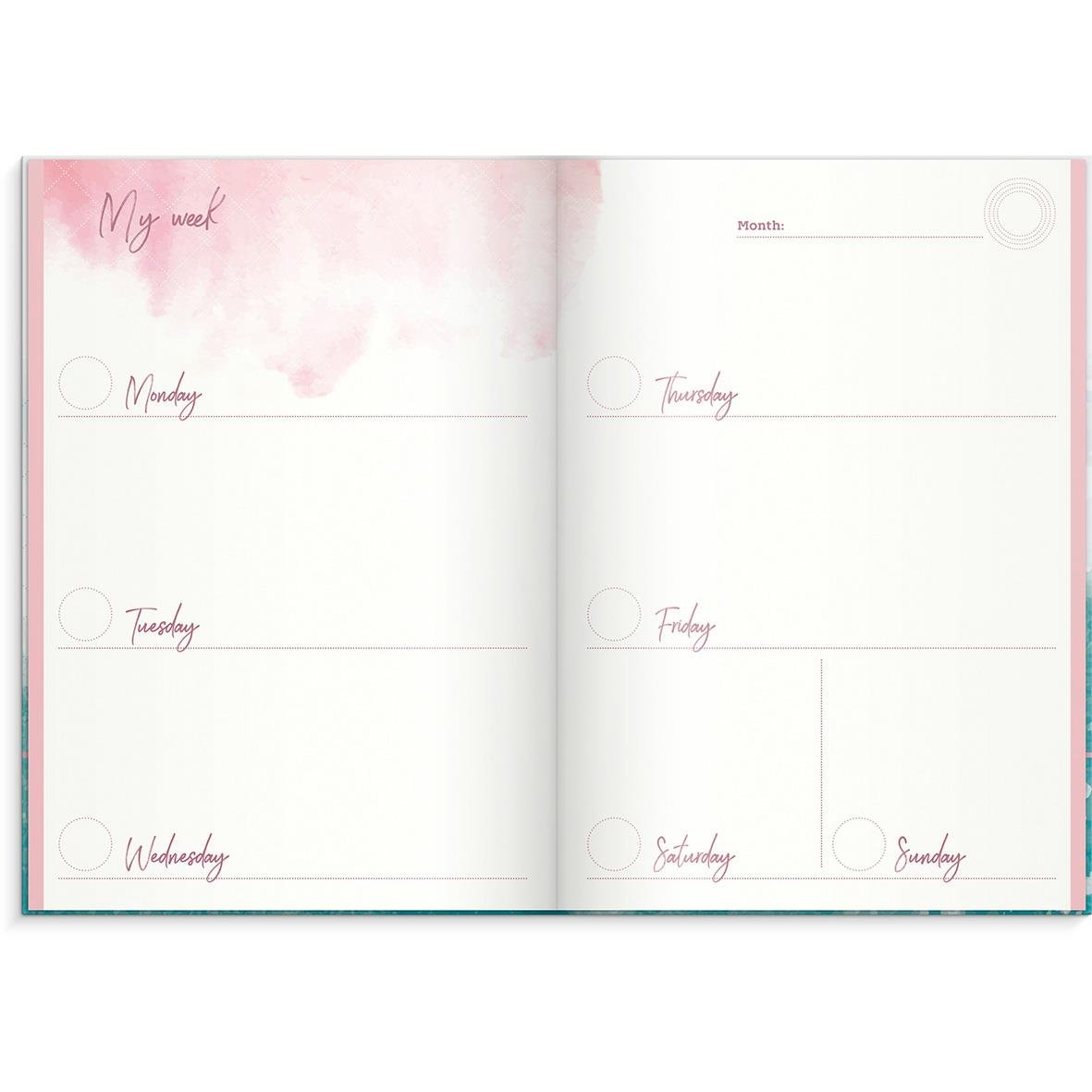 Öppnad almanacka med veckoplanering för måndag till söndag, rosa och vit design, titeln Detta är mitt år