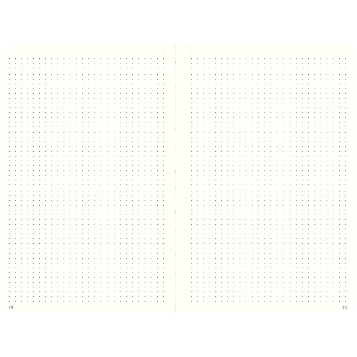 Rosa anteckningsbok med prickade sidor och diskret punktmönster