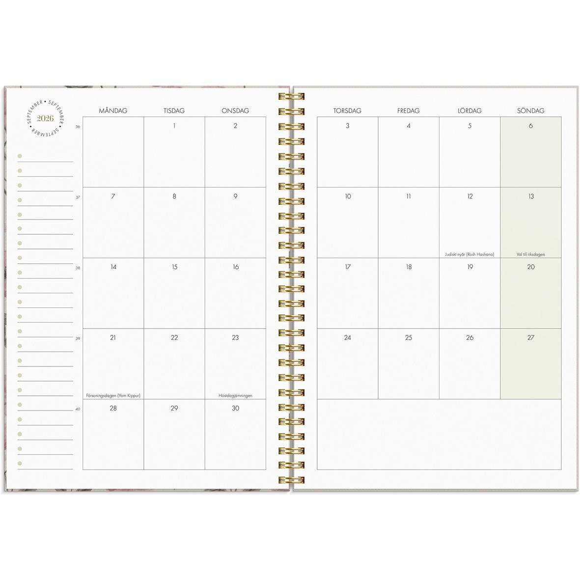 Öppen kalender för 2026 med veckoplanering i A5-format, guldfärgad spiralbindning och plats för anteckningar