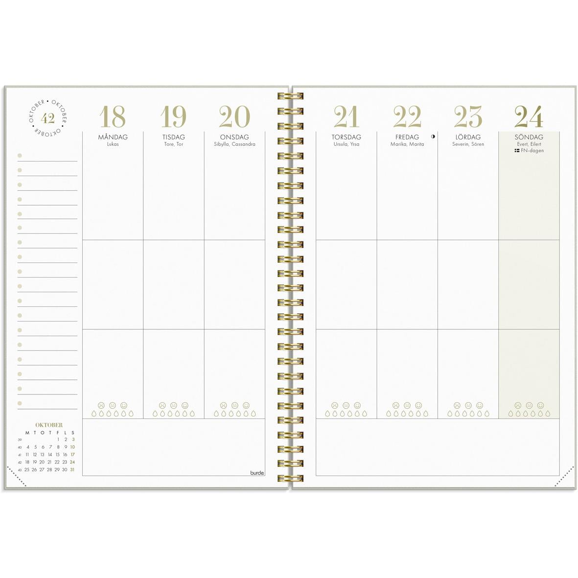 Öppen kalender för 2026 med veckoplanering i A5-format, guldfärgad spiralbindning och plats för anteckningar