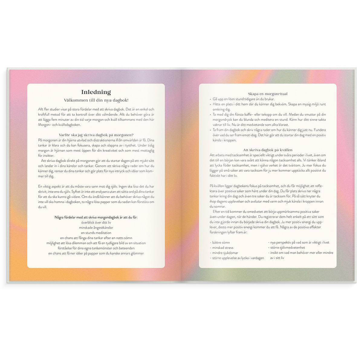 Öppnad dagbok med rosa, orange och grön färggradient, visar introduktionstext på två sidor