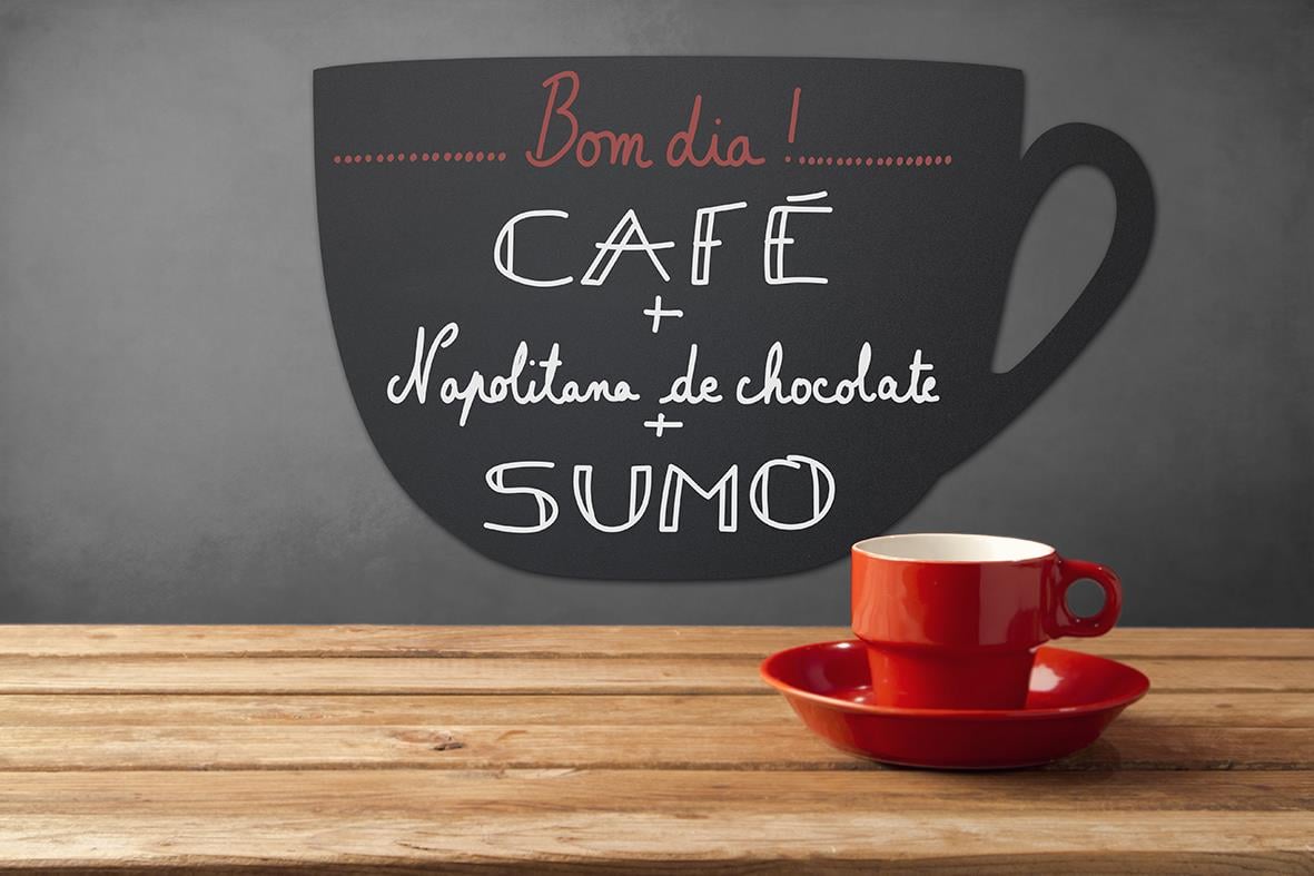Svart griffeltavla i form av en kaffekopp med text om café och choklad