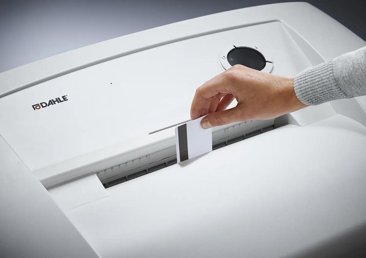 Hand som matar papper i en Dahle dokumentförstörare
