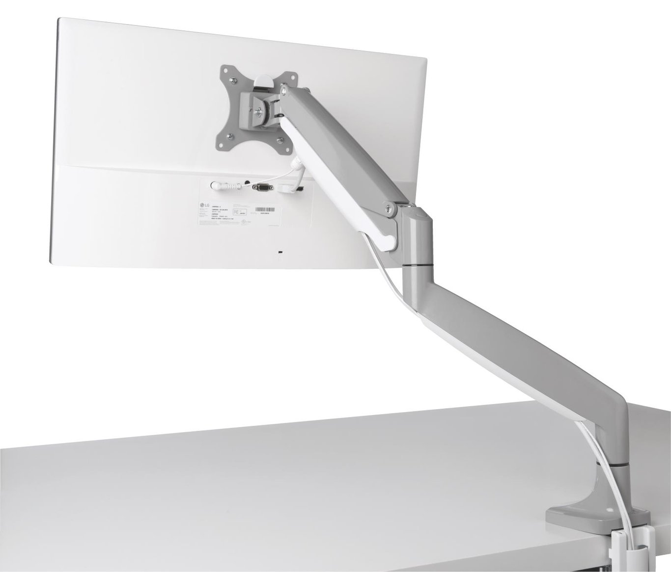 Grå Kensington SmartFit One Touch monitorarm monterad på skrivbord