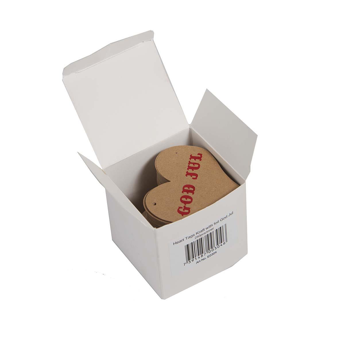 Hängetikett i form av ett hjärta med texten God Jul i rött, i en vit box