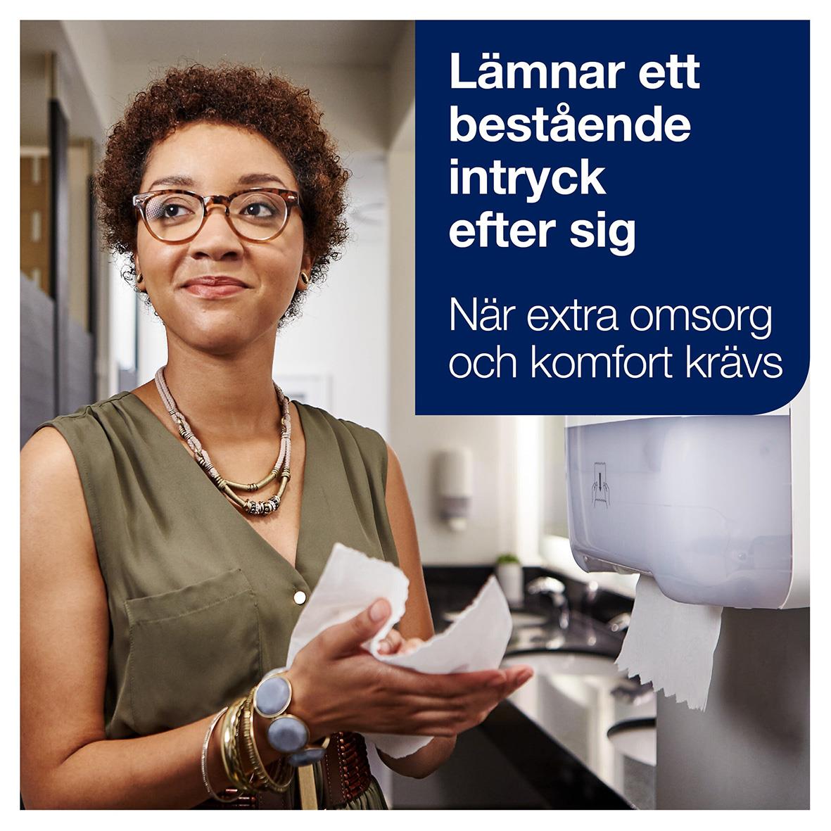 Kvinna med glasögon och armband som använder pappershandduk i kök eller arbetsmiljö