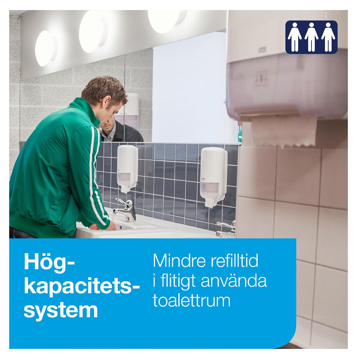 Man använder en vit pappershanddukstork i ett offentligt toalettutrymme med blå väggar och handduksdispens.