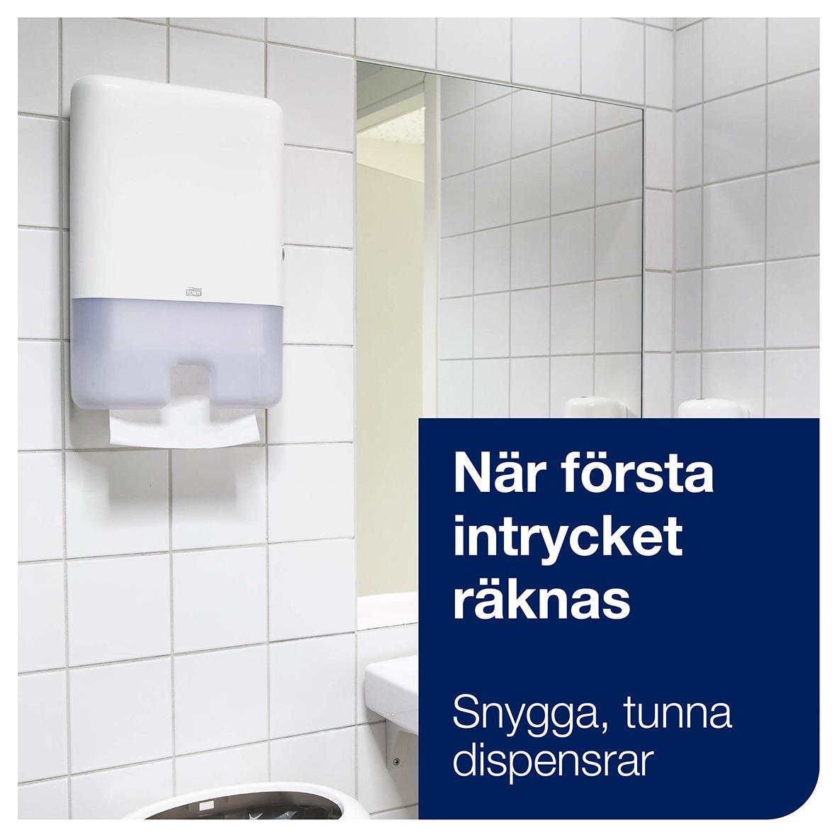 Vitt pappershanddukdispenser för tork, väggmonterad i badrum med spegel och vita kakel