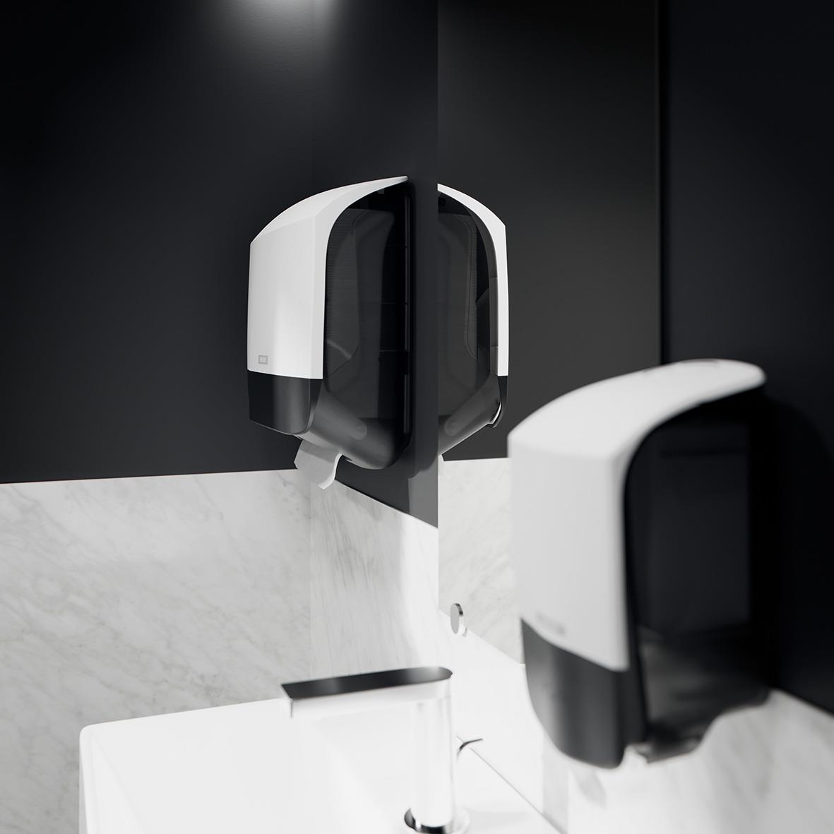 Vit Katrin S pappershanddukdispenser i svart och vitt monterad på svart vägg