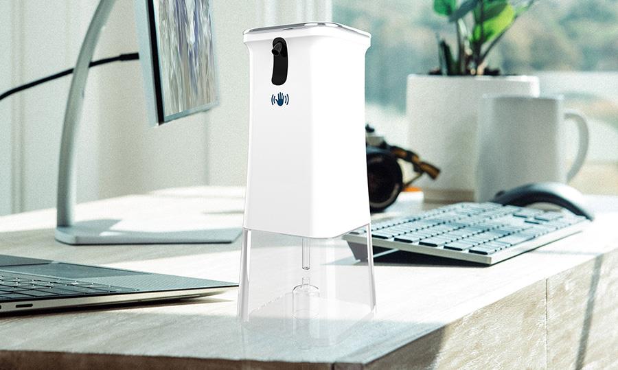 Automatisk handdesinfektionsdispenser på skrivbord i kontorsmiljö