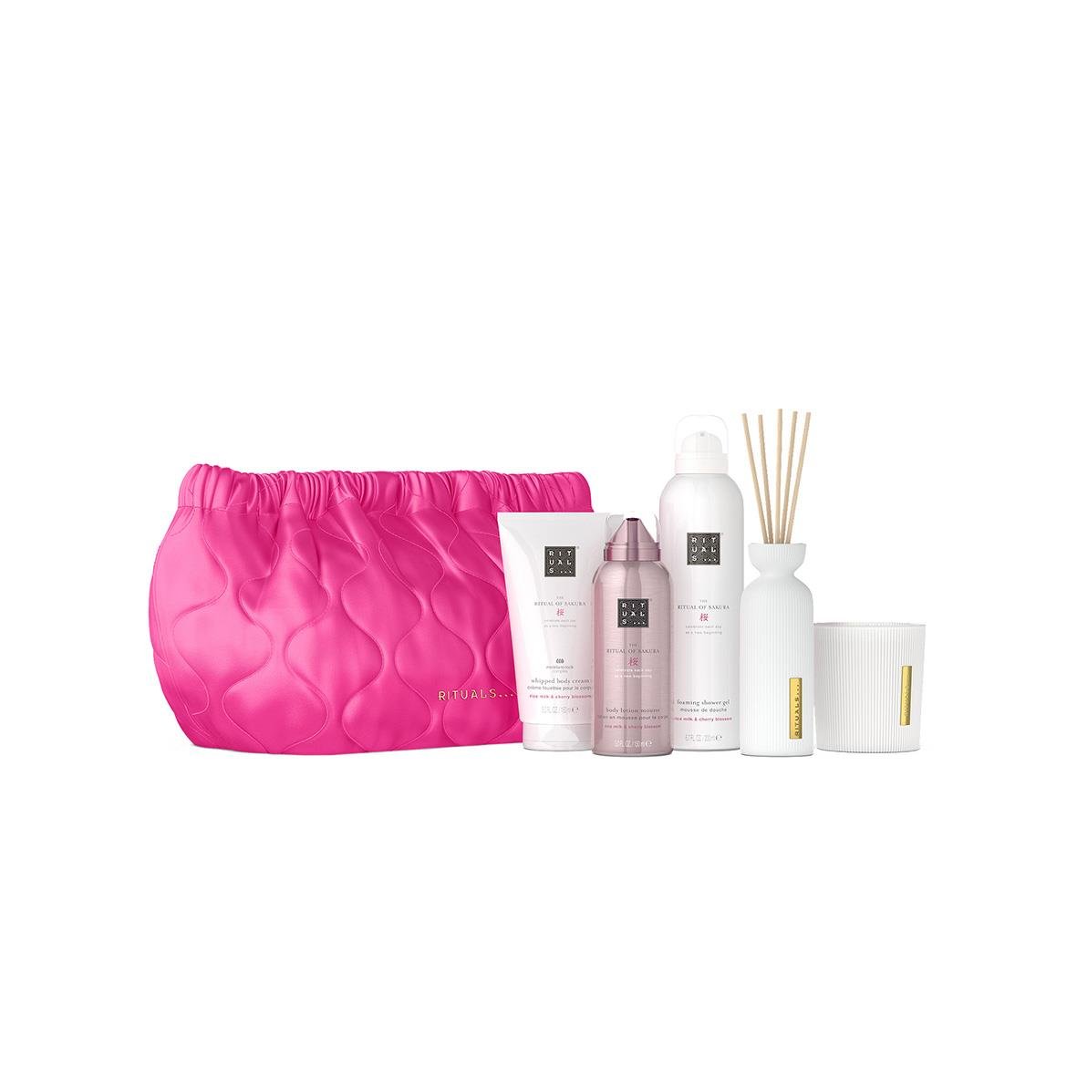 Vård- och doftprodukter med rosa väska, inklusive lotion, spray, doftstickor och ljus