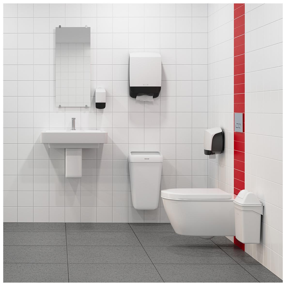 Vit Katrin tvål dispenser på badrumsvägg med spegel och toalett