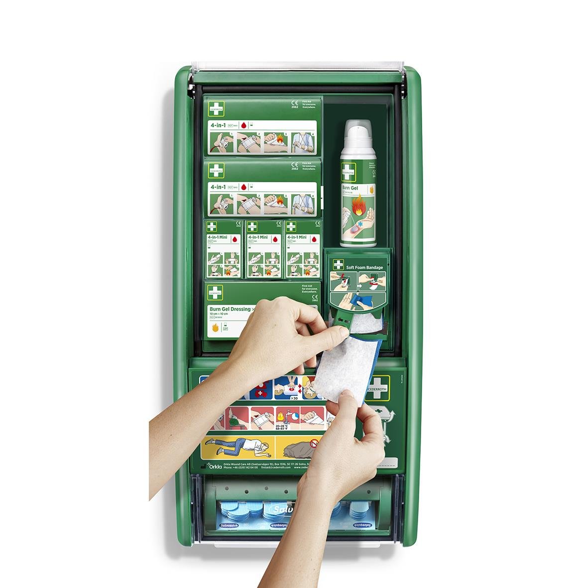 Första hjälpen station för brännskador med olika förbandsmaterial och instruktioner