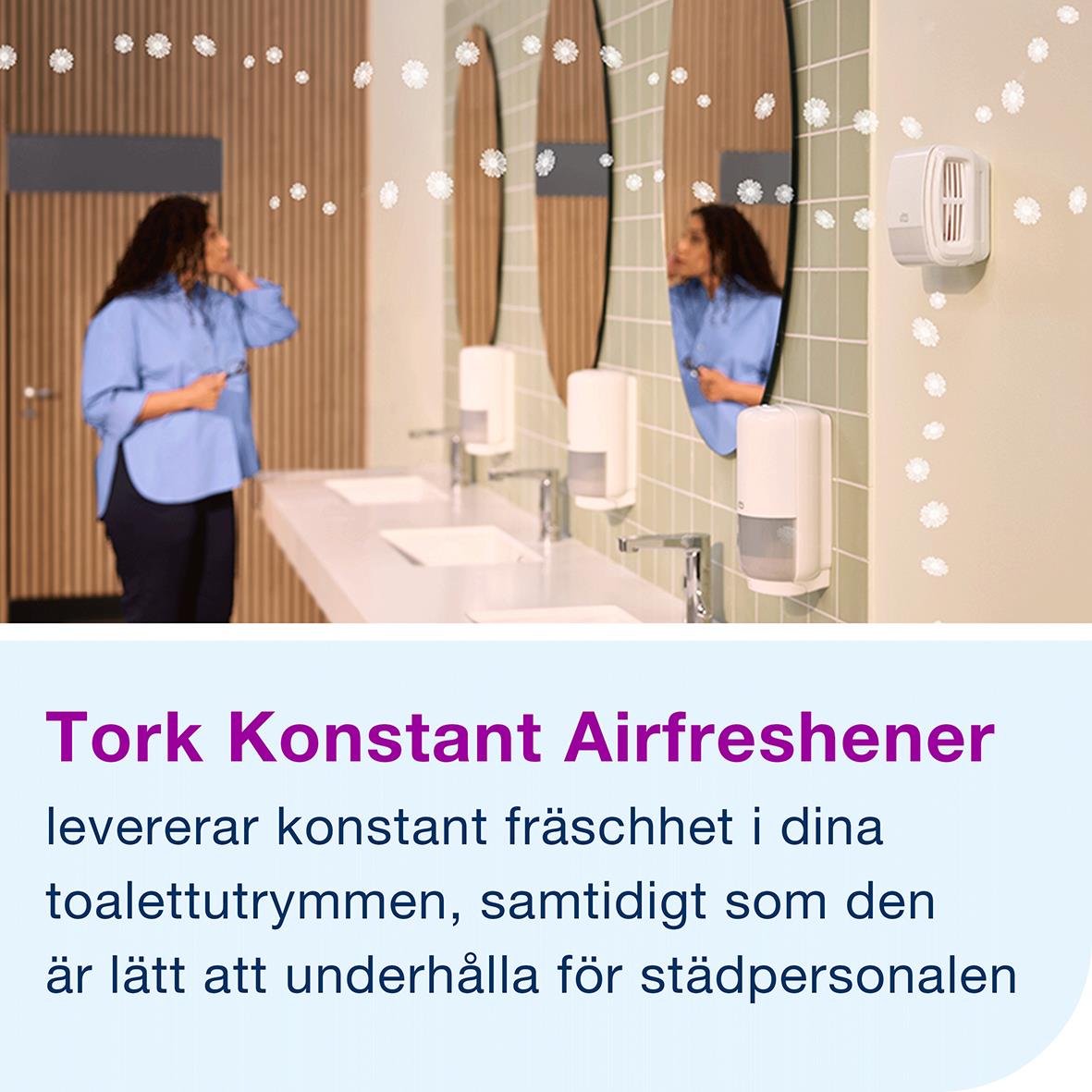 Tork Konstant luftfräschare i badrum med speglar och handduksautomater