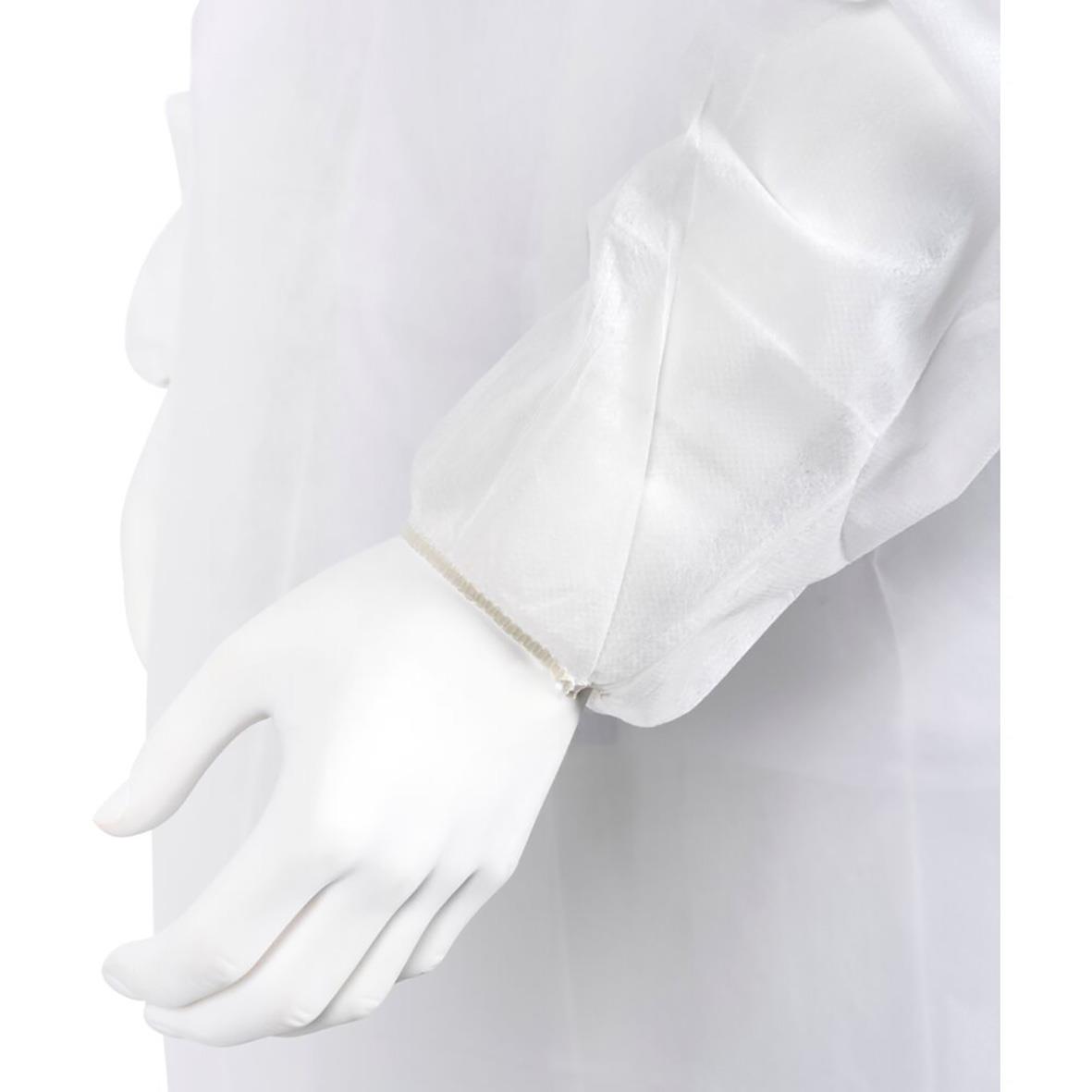 Skyddshandskar och vit skyddsoverall för medicinskt eller laboratoriebruk