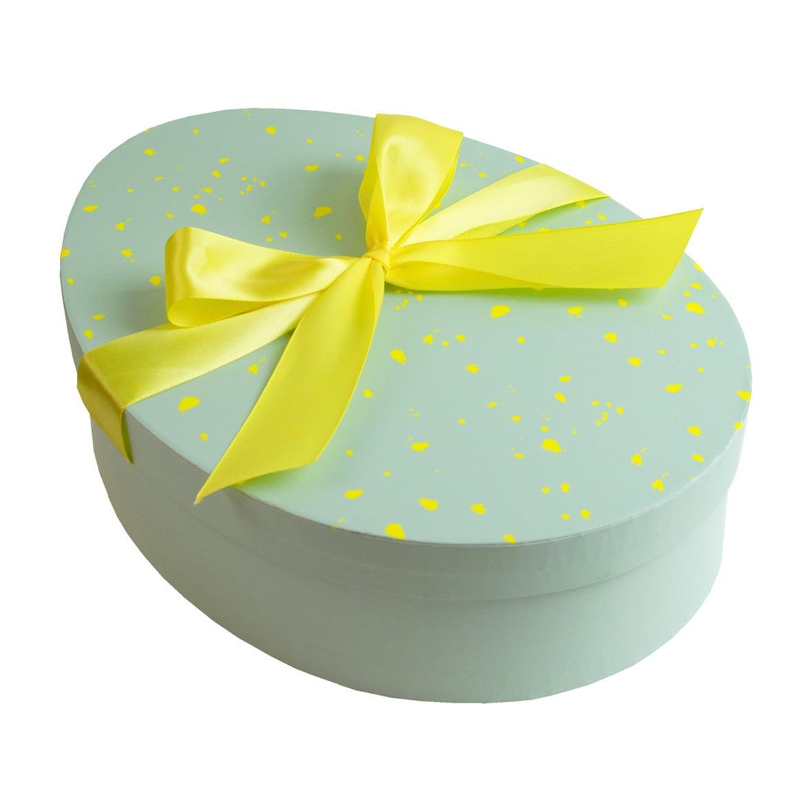 Rund presentask med ljusblått lock och guldfärgad rosett