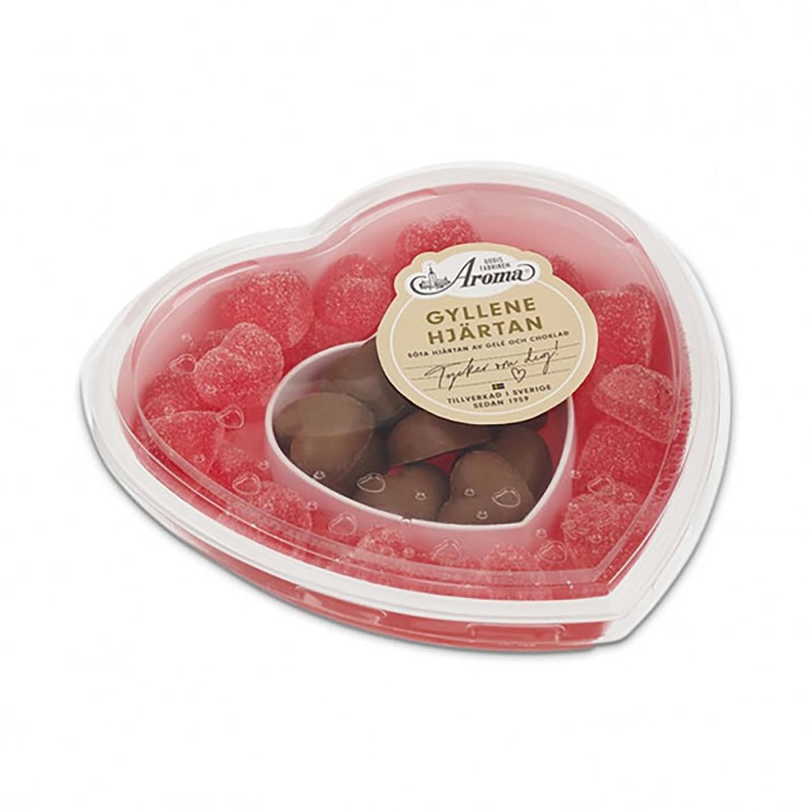 Gyllene Hjärtan godis i hjärtformat plastask med rosa och brunt godis