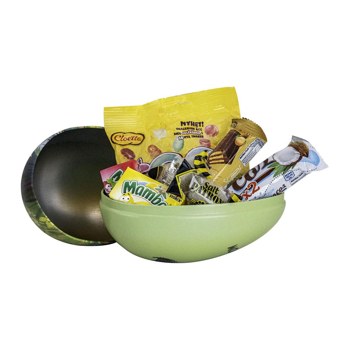 Påskägg med tre Muminmotiv och godis i en grön skål
