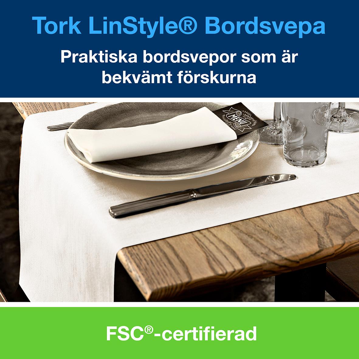 Vit bordsväv Tork LinStyle 0,4x24m på dukad bord med tallrik, kniv och glas