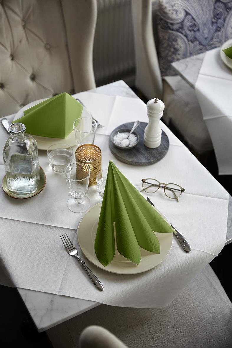 Servett Duni Dunilin Leaf Green 40x40cm på dukat bord med glas, salt och peppar, bestick och ljuslyktor