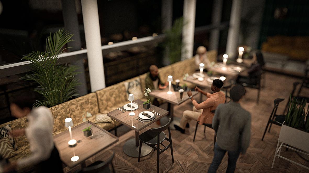 Bordslampa LED Securit Feline Vit på ett bord i en restaurang eller café med sittande gäster och växter i bakgrunden