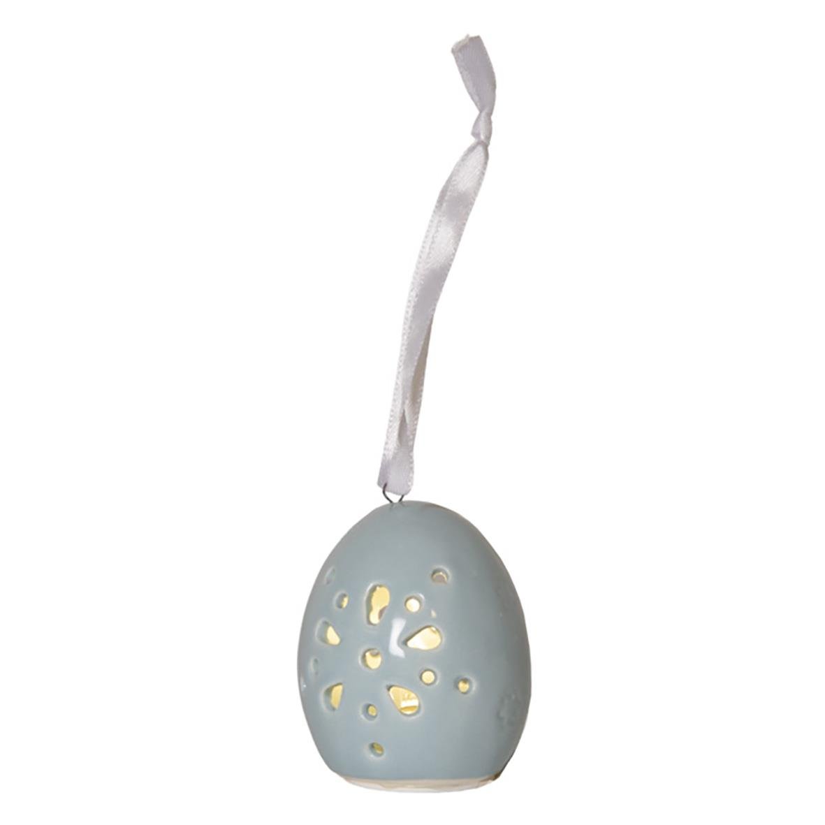 Dekorationsfigur av en äggformad Esther med hål och ett vitt band