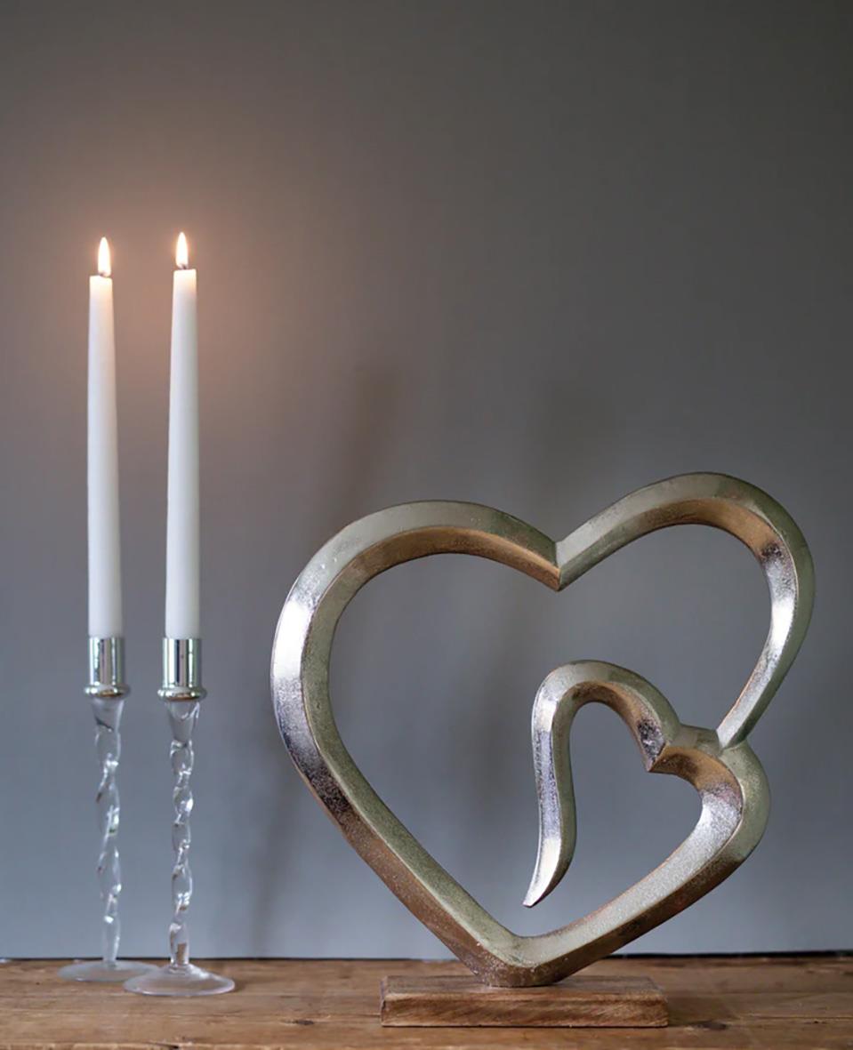 Ljusstake Dorre Glas med silvertopp 27cm formad som ett hjärta med två ljus på en träyta