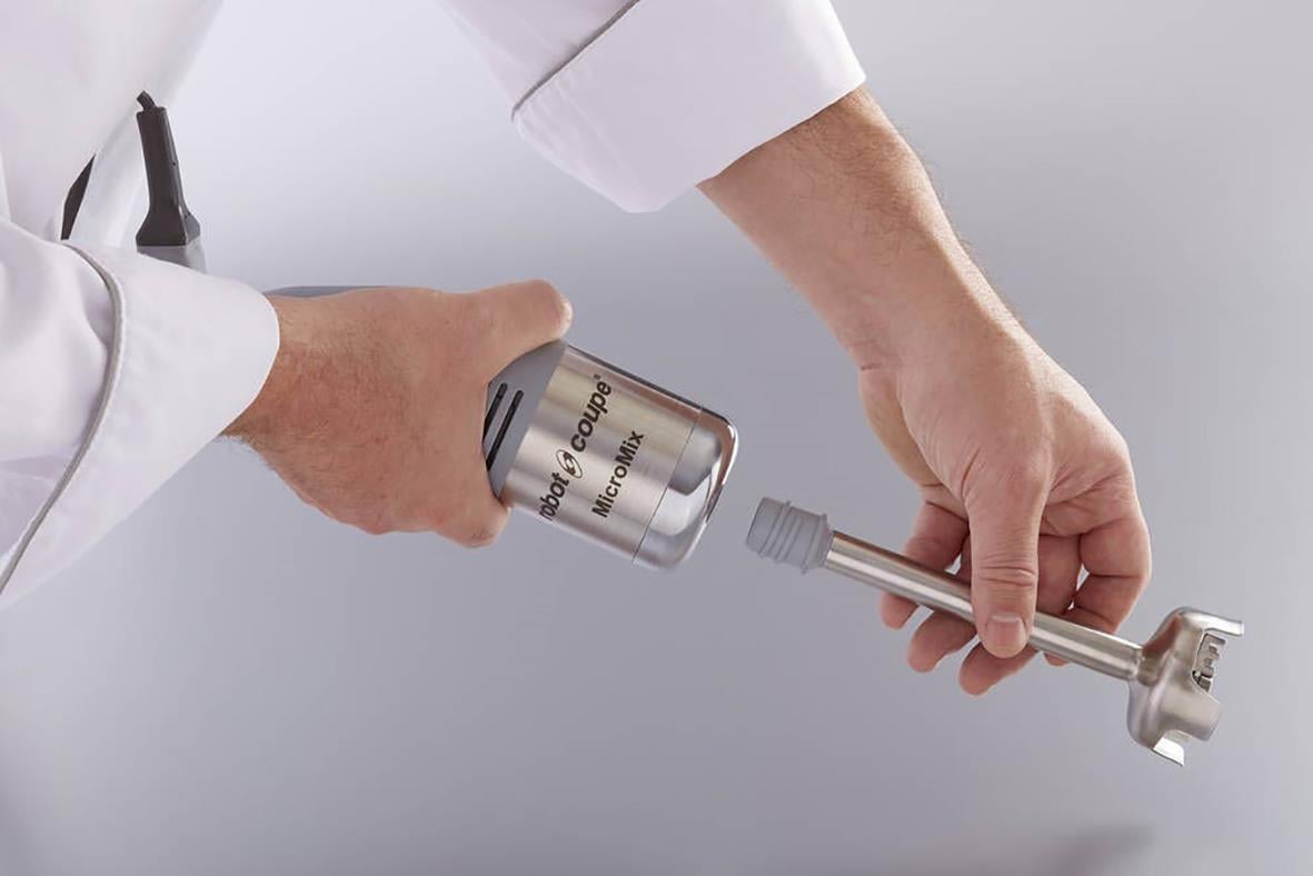 Person som använder en Stavmixer Robot Coupe MicroMix för att mixa i en behållare