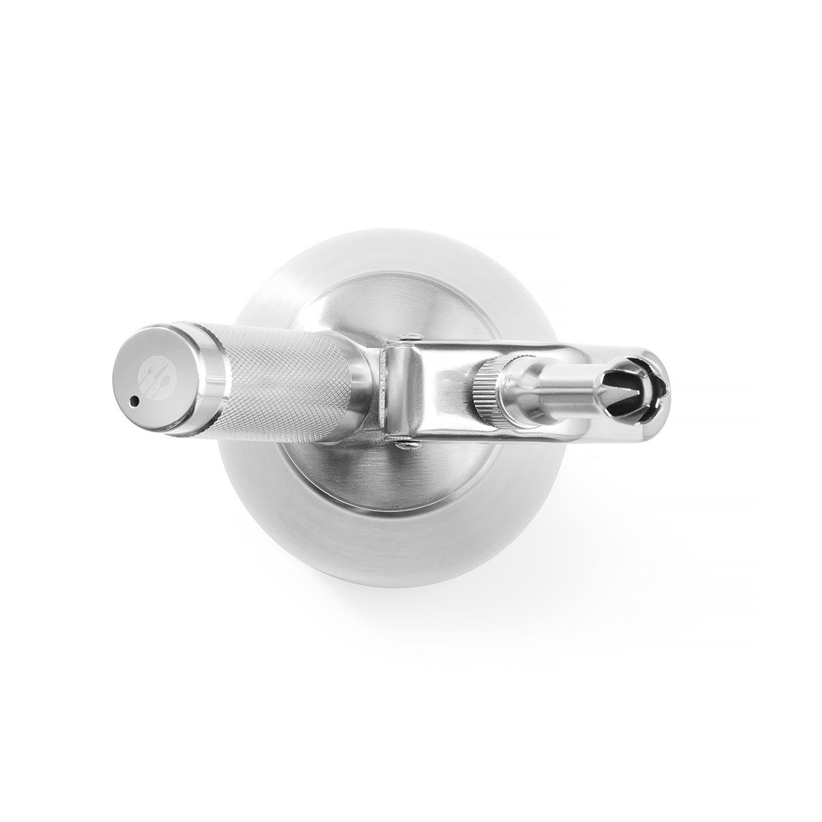 Metallic medicinsk instrument med två handtag och rund bas sett ovanifrån