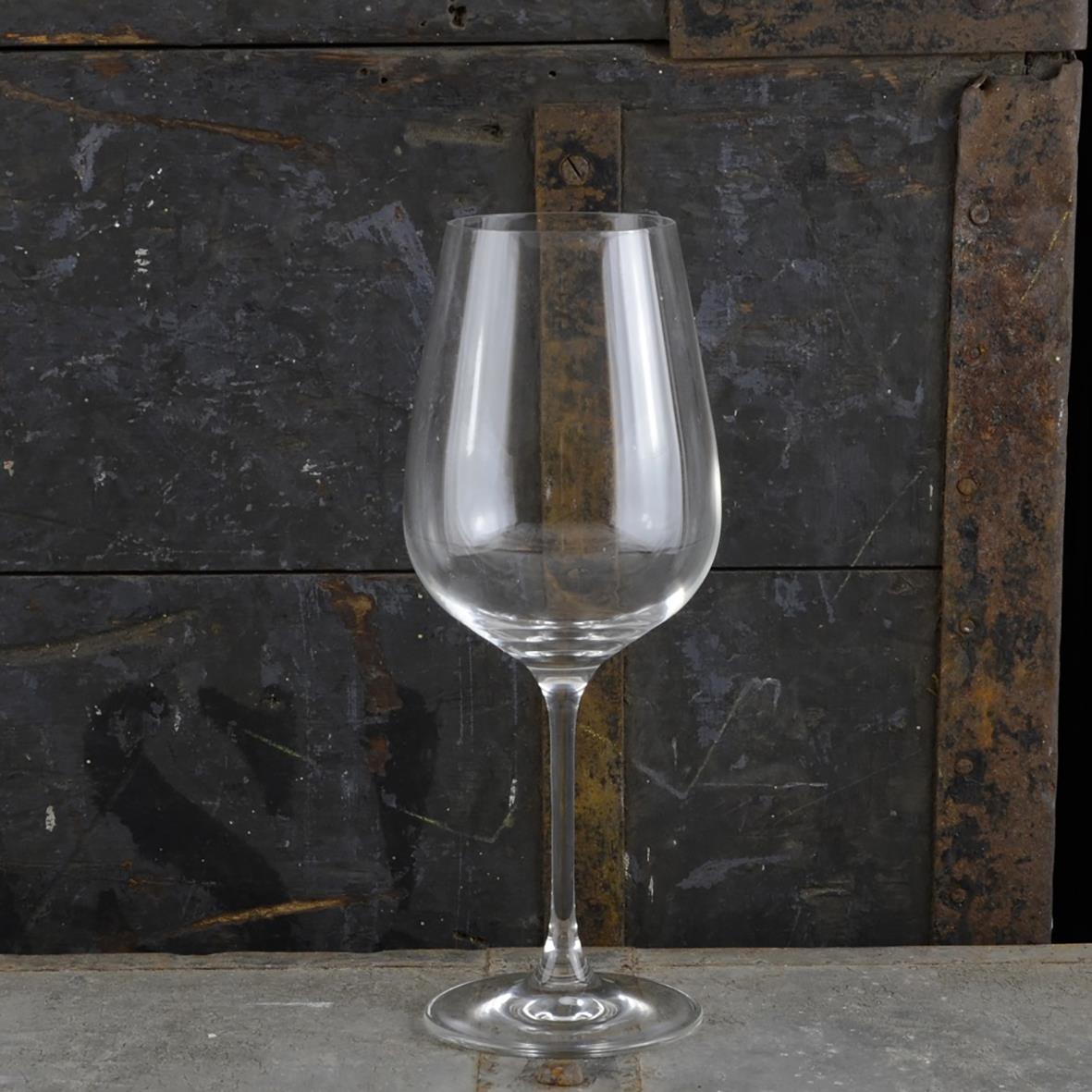 Vinglas Accent Rona 48cl står på en träbänk mot en mörk trävägg