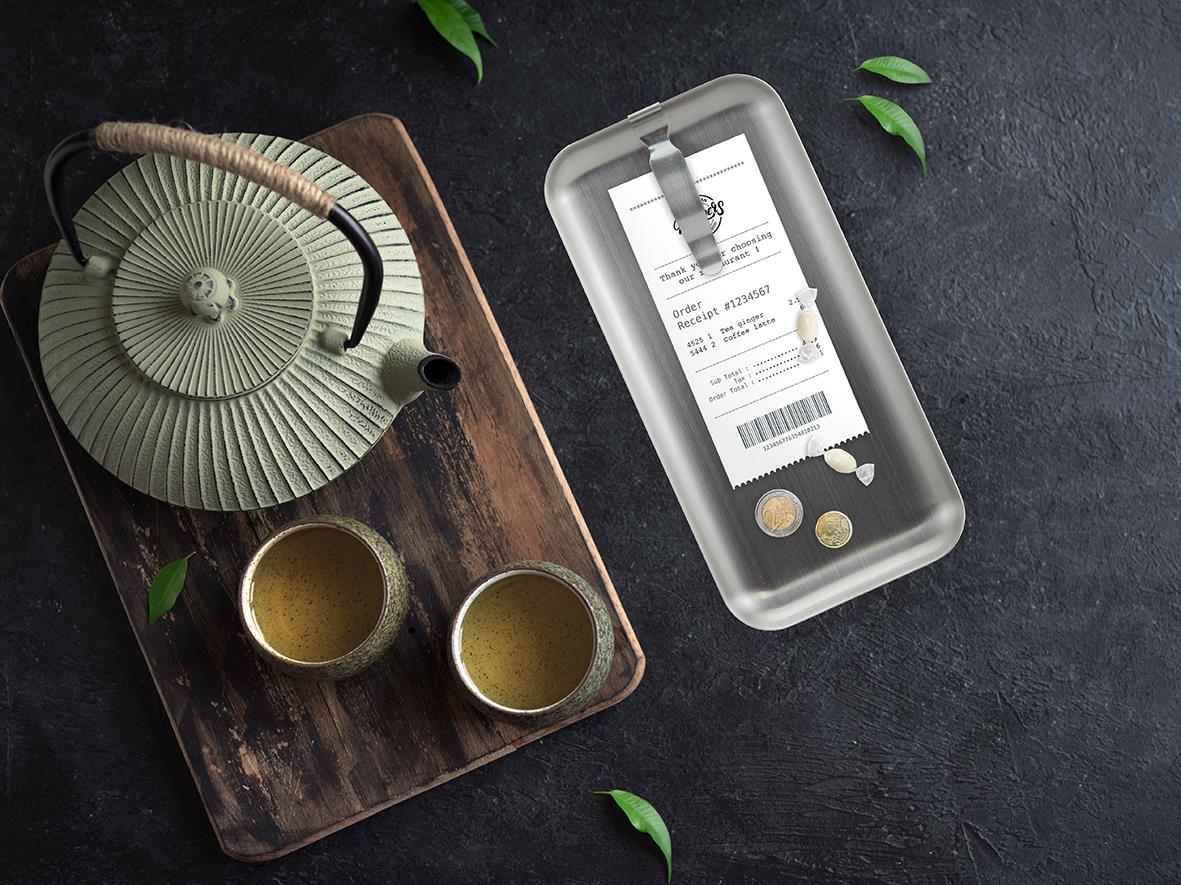 Notbricka i stål med klämma, mått 28,5x9cm, på träbricka med te och växter