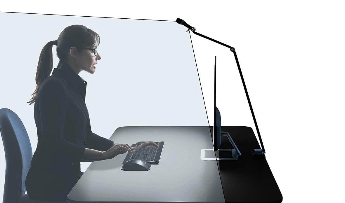 Bordslampa Sun-Flex Screenlite i svart på ett skrivbord