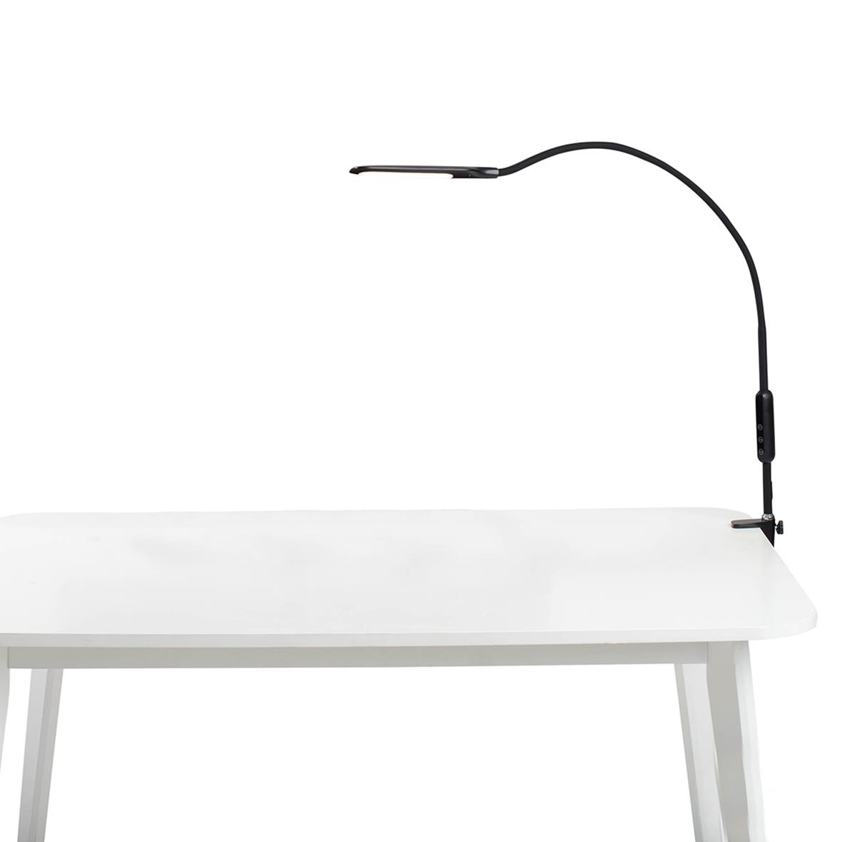 Svart bordslampa Sun-Flex Desklite med flexibel arm på ett vitt bord