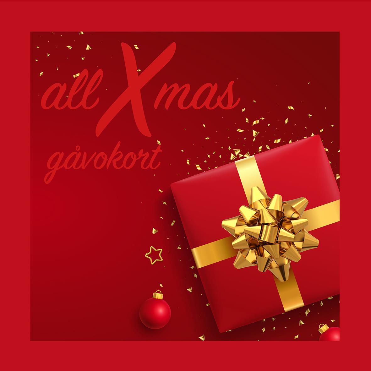 Rött julgåvokort med guldrosett och present, juldekorationer och konfetti