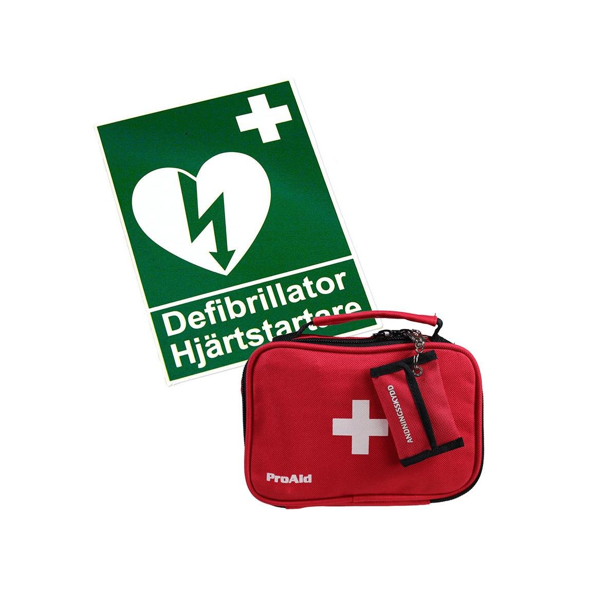 Hjärtstartare och defibrillator i röd väska med hjärtstartarsymbol och informationsskylt