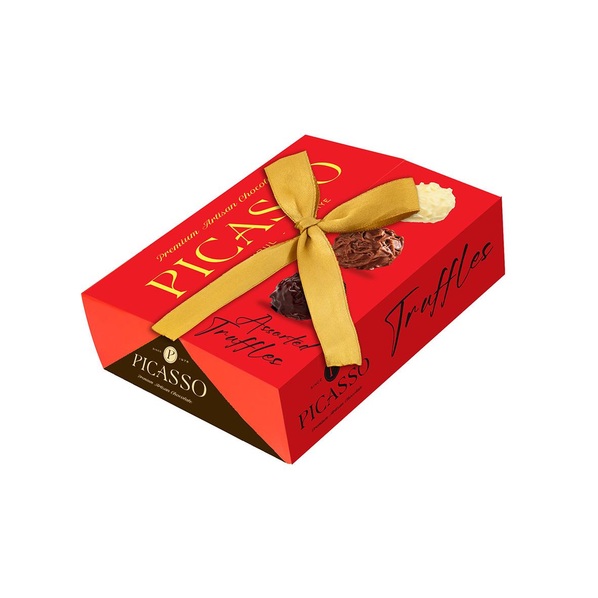 Röd box med guldrosett och chokladtryfflar från Picasso