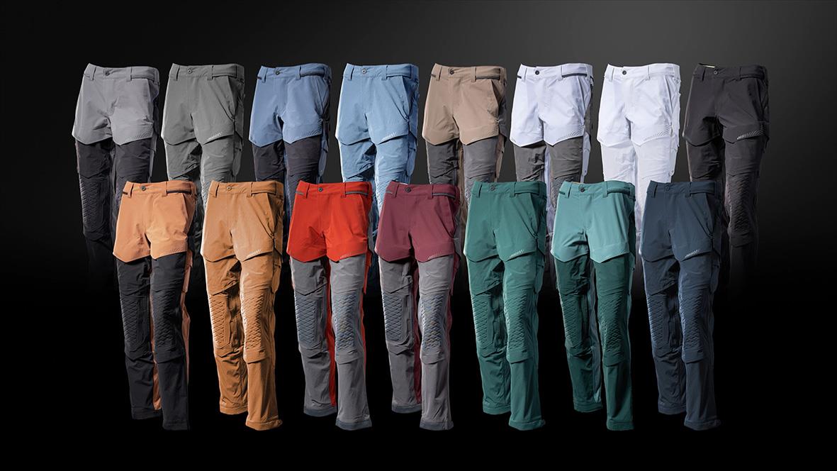 Flera par arbetsbyxor i olika färger, inklusive grå, blå, beige, vit, svart, orange, röd, grön och mörkblå