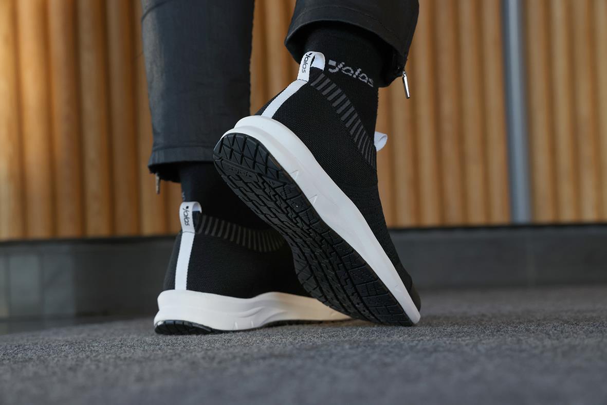 Svarta och vita sportskor med högt skaft och dragkedja på sidan