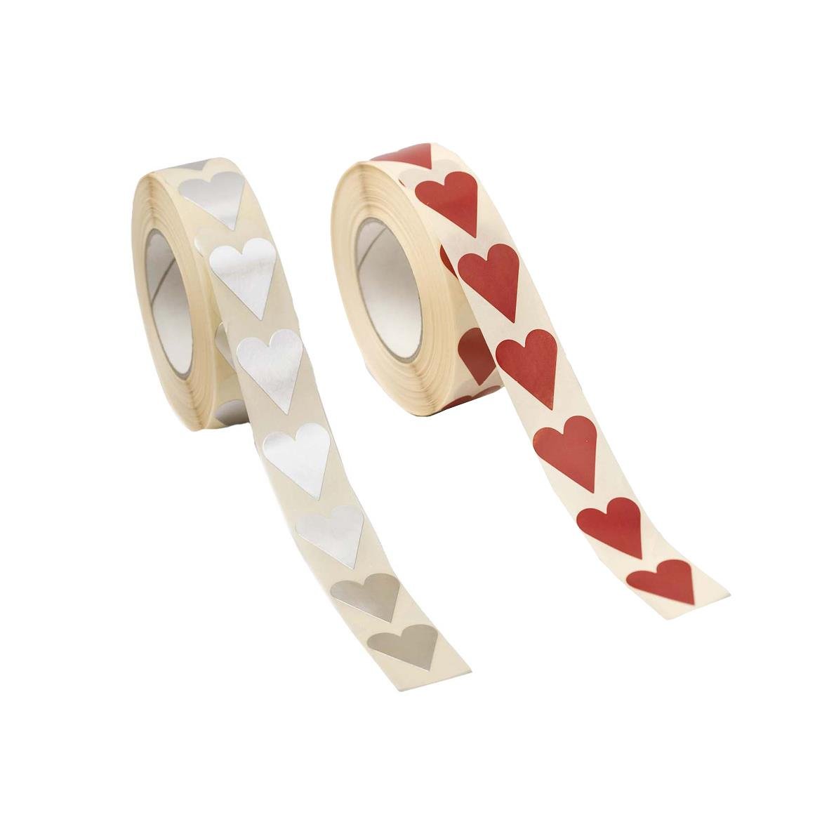 Två rullar med hjärtformade etiketter, en med vita hjärtan och en med röda hjärtan, 20x23mm