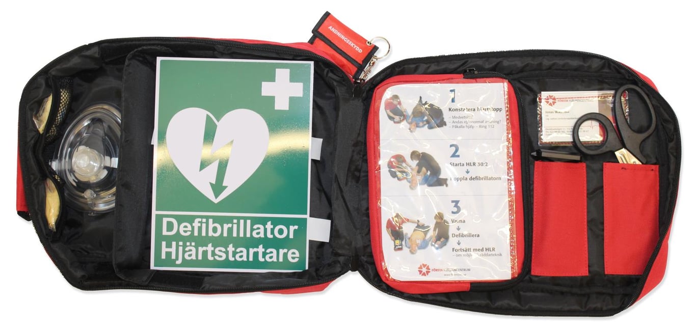 Väska med hjärtstartare och defibrillator, innehåller instruktioner och medicinska verktyg