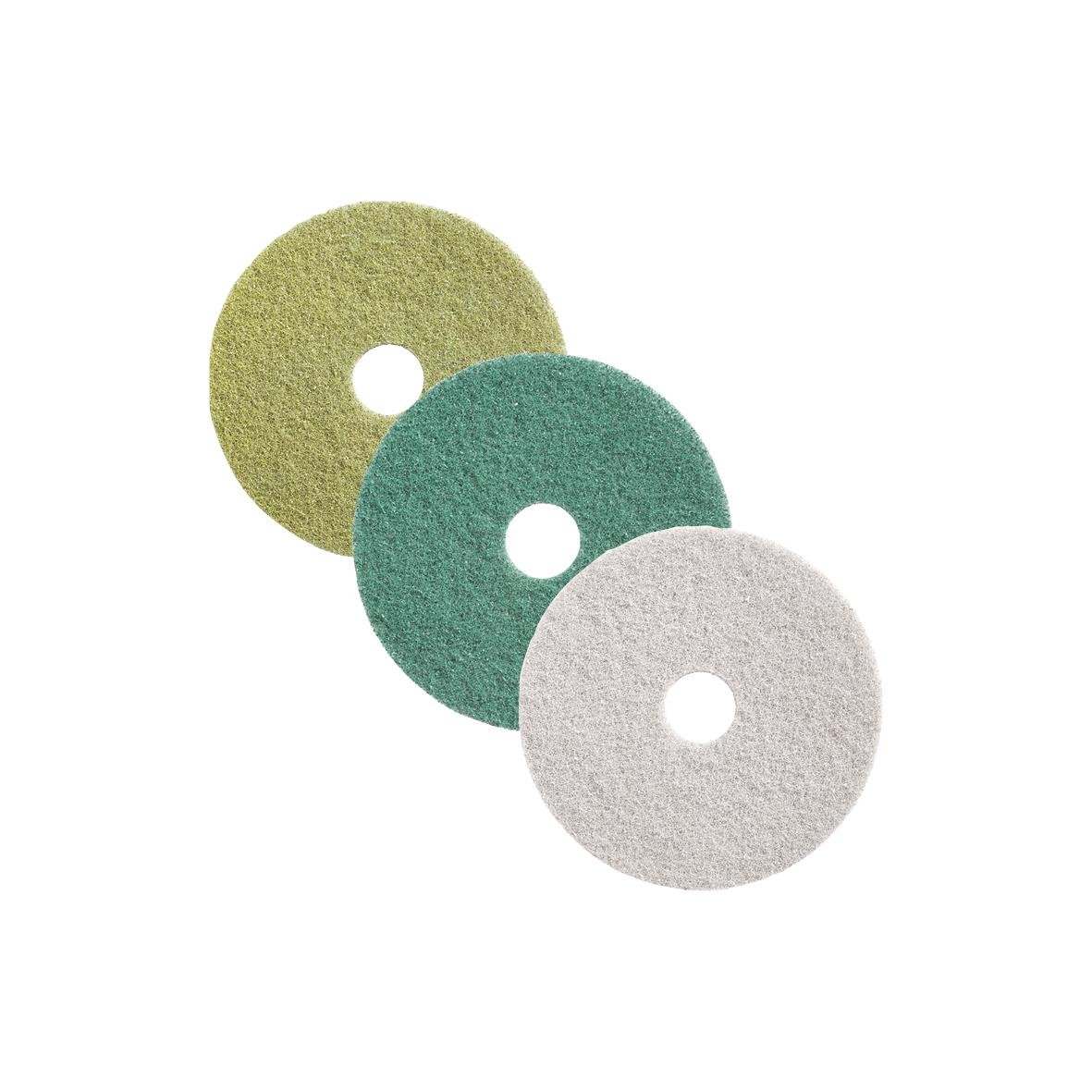 Tre färgade skivor med hål i mitten, gröna, blå och vita, mot vit bakgrund