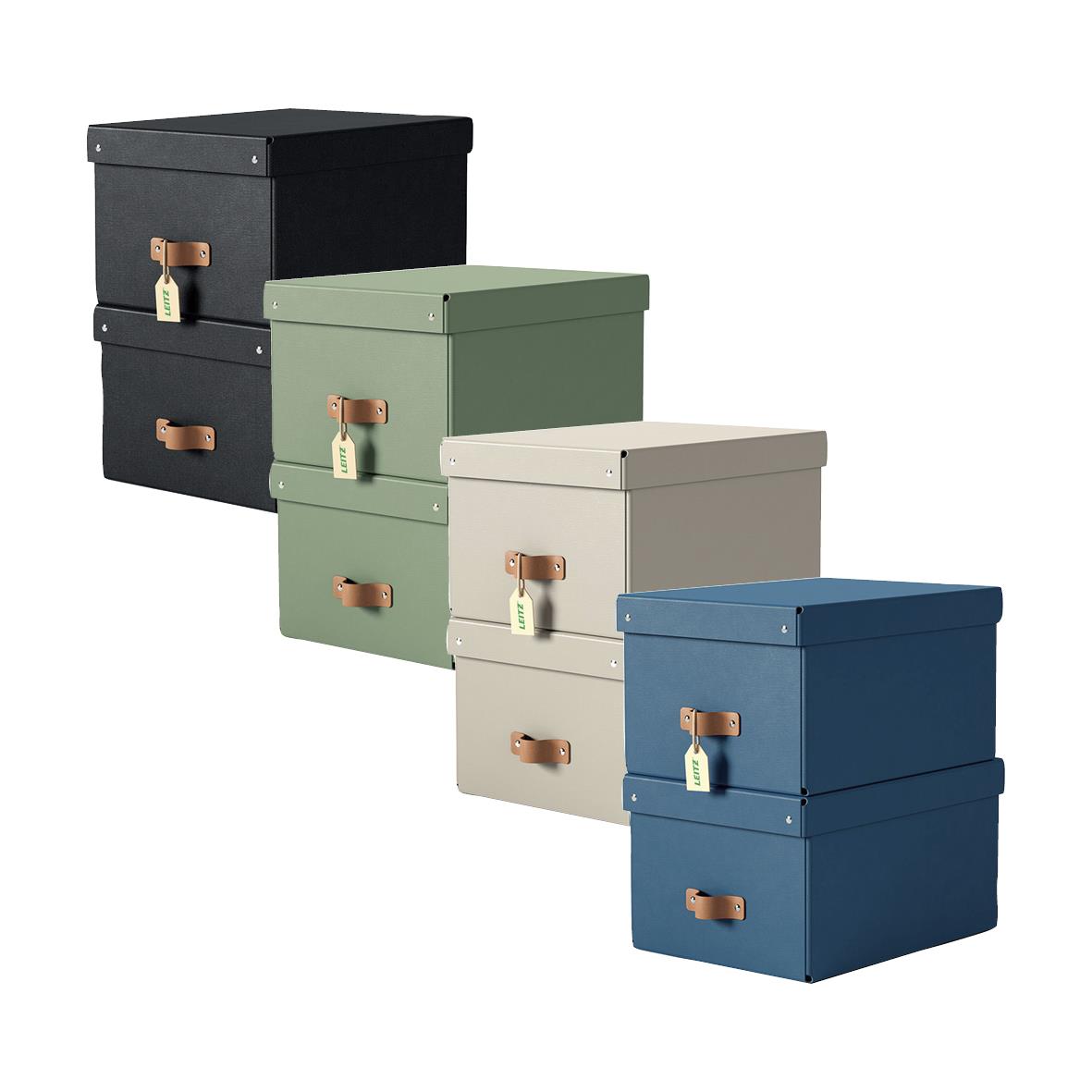 Fyra färgade förvaringsboxar i svart, grönt, beige och blått med läderhandtag och lås