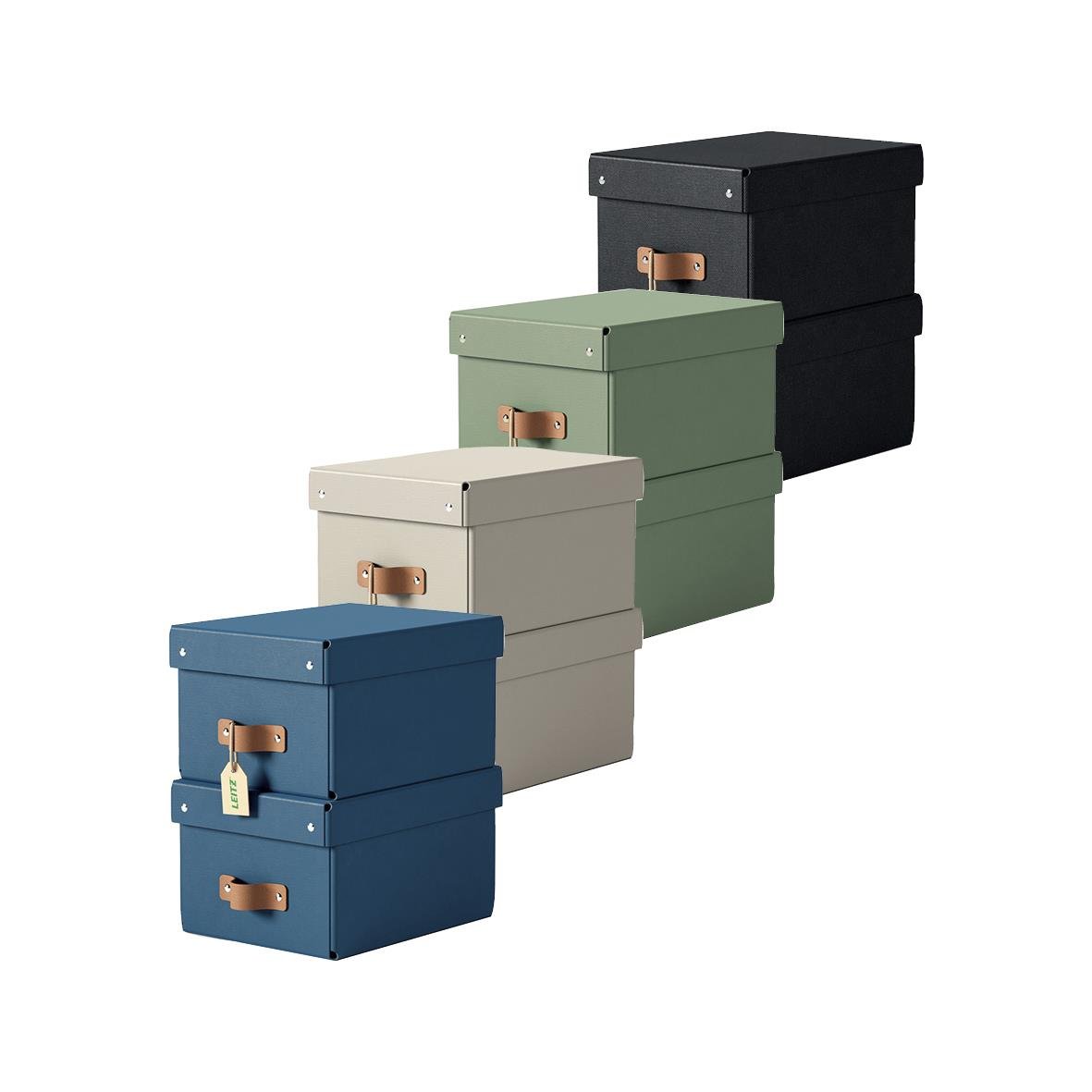Fyra färgade förvaringsboxar i svart, grönt, beige och blå med läderhandtag och lås